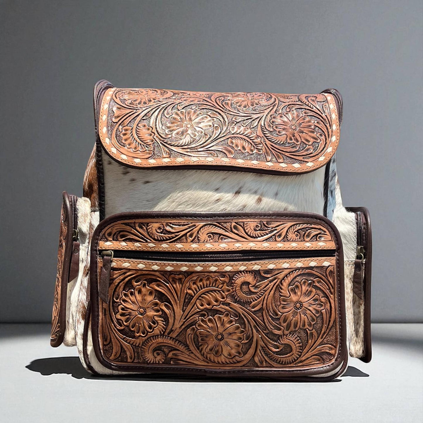 Brown tooled leather & cowhide backpack